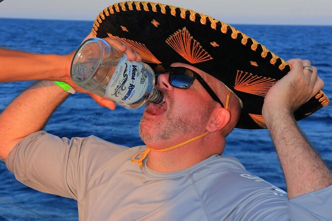 Los Cabos Catamaran Cruise with Open Bar & Light Snack - The vibe on a catamaran: crew, music, smoking, and tequila shots